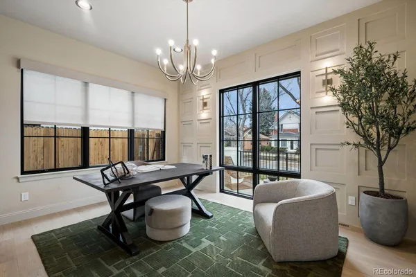 a living room with furniture a chandelier and a table