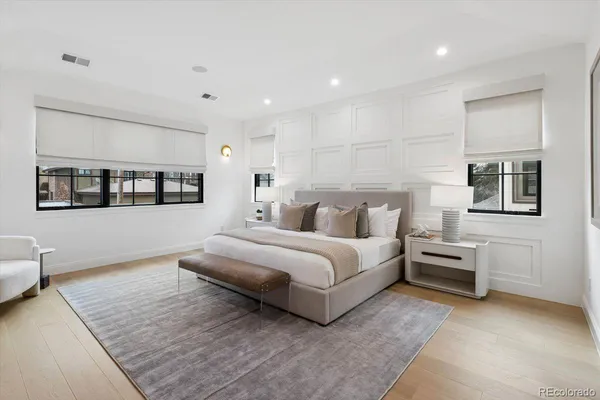 a spacious bedroom with a bed and a couch