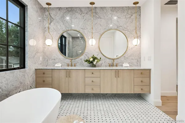 a bathroom with a bathtub and a double vanity sink