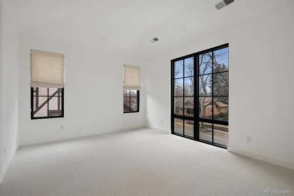 a bathroom with a granite countertop sink a toilet and shower