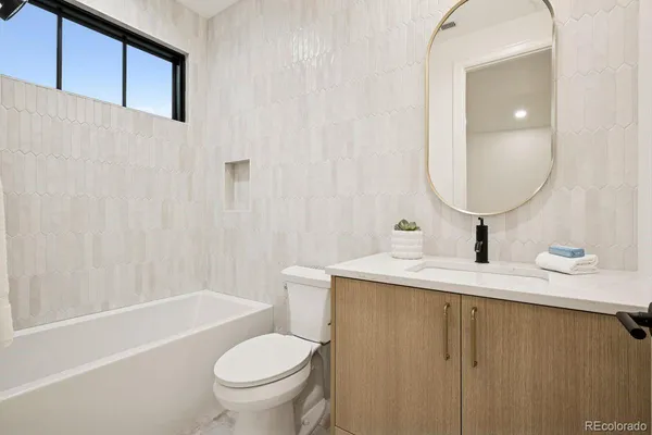 a living room with kitchen island furniture and a view of kitchen