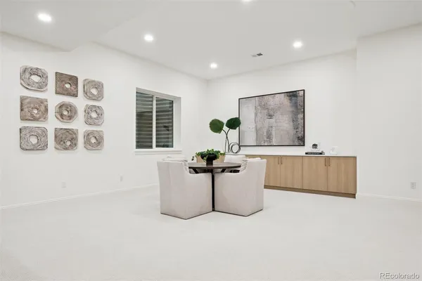 a living room with furniture potted plant and a window