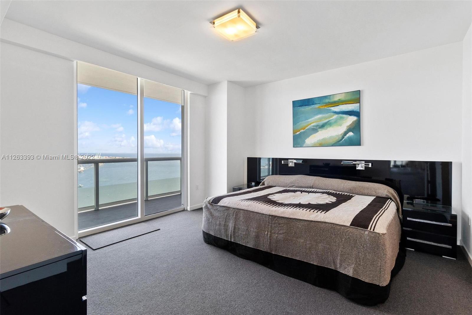 50 Biscayne Boulevard, Unit 4802 Miami, FL 33132 - Photo 16 of 33 a bedroom with a bed and a desk
