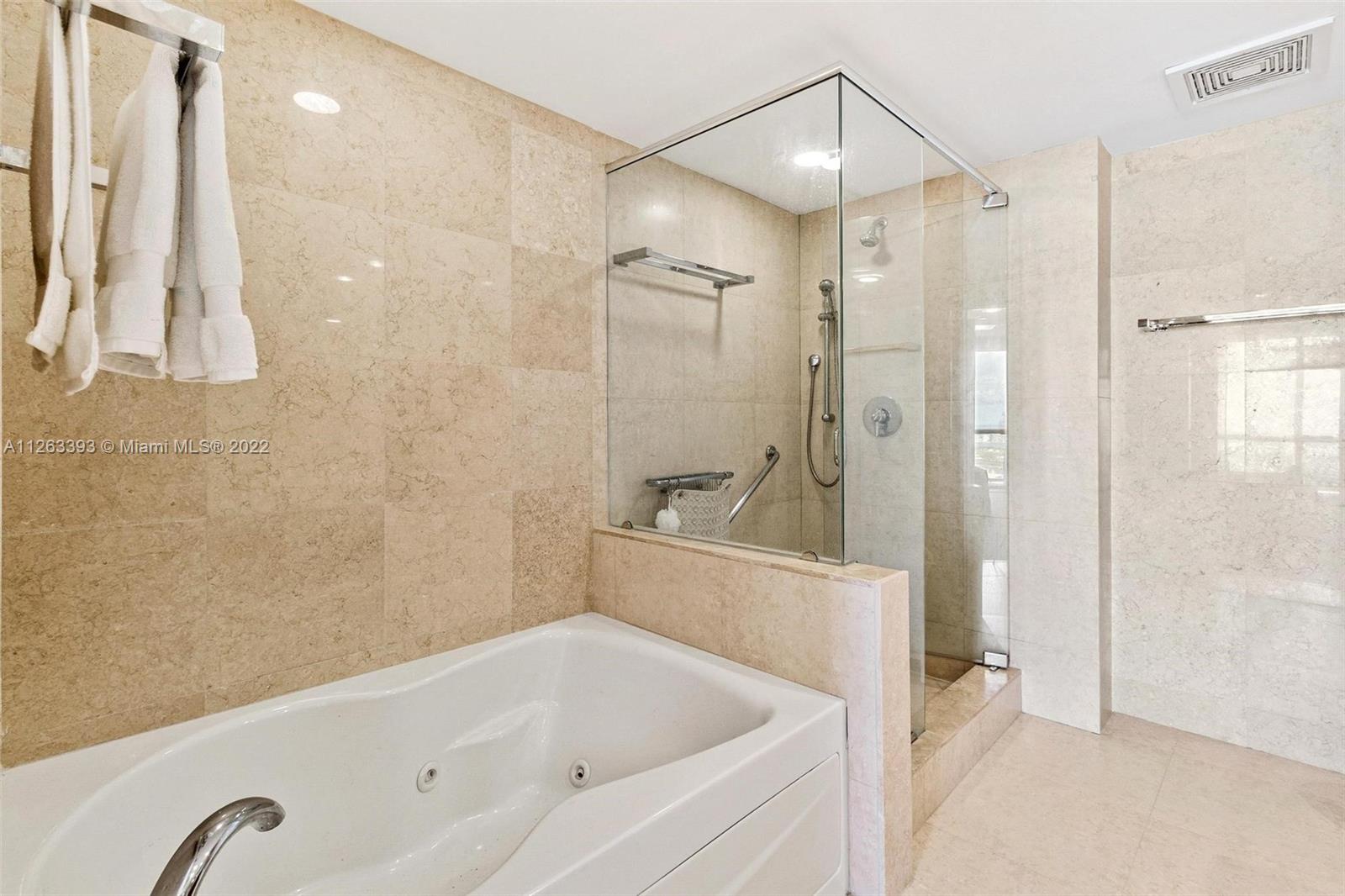 50 Biscayne Boulevard, Unit 4802 Miami, FL 33132 - Photo 20 of 33 a bathroom with a tub a sink and a shower