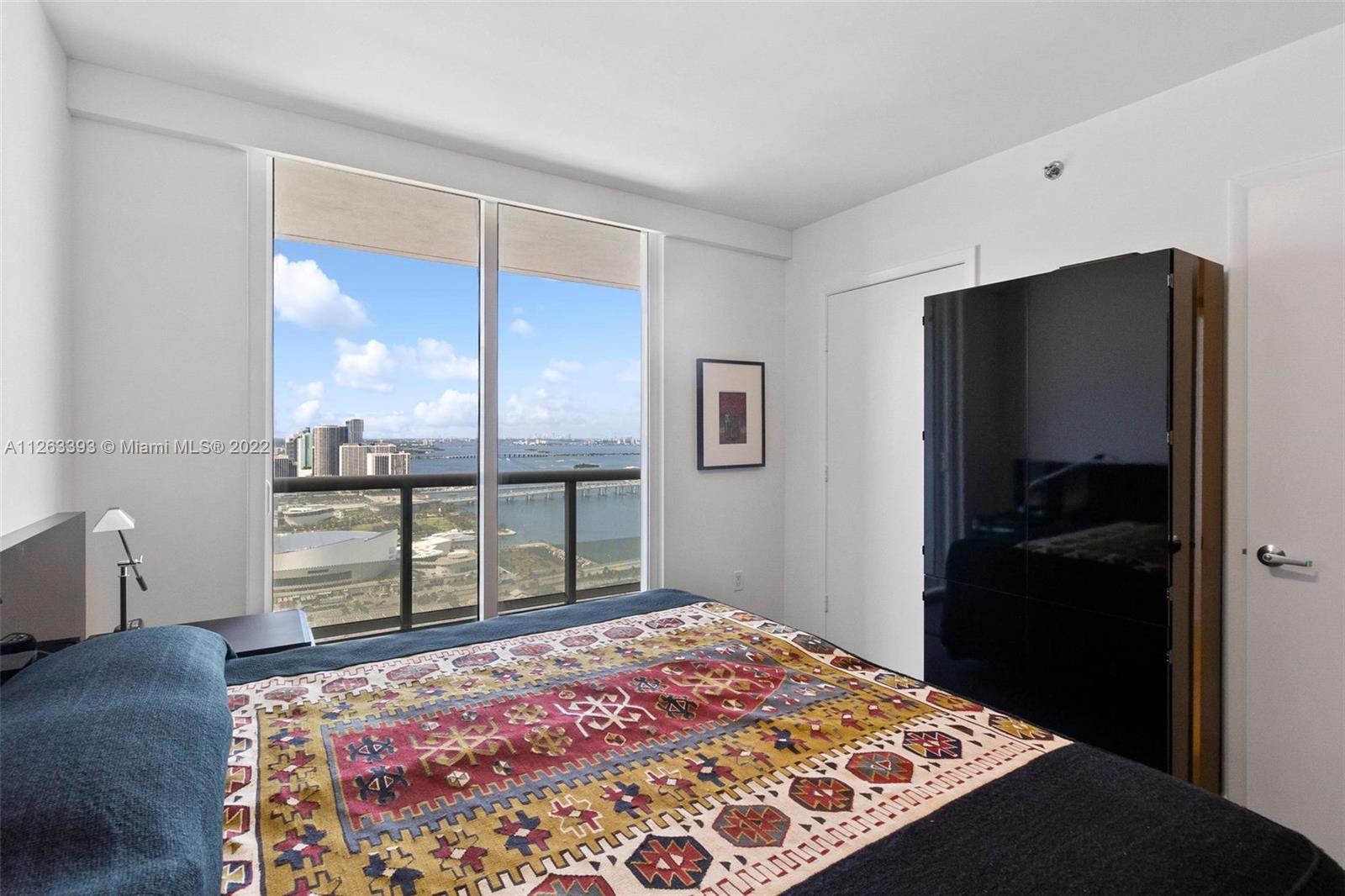 50 Biscayne Boulevard, Unit 4802 Miami, FL 33132 - Photo 23 of 33 a bedroom with a bed and a dresser