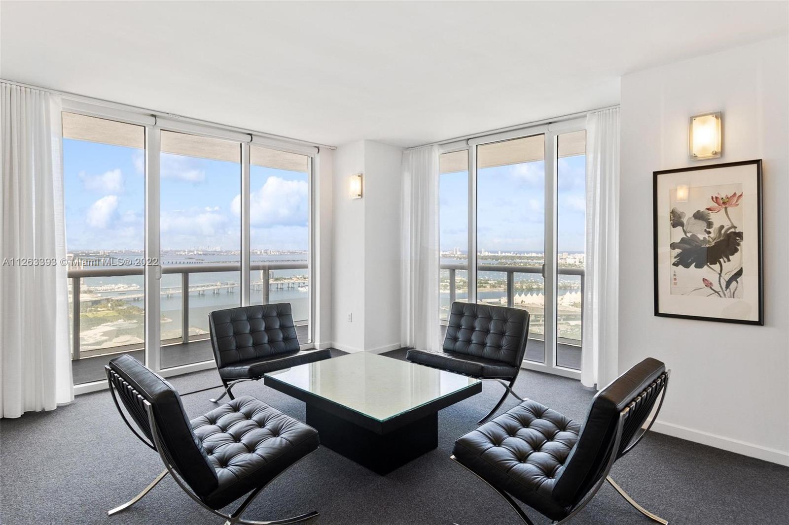 50 Biscayne Boulevard, Unit 4802 Miami, FL 33132 - Photo 6 of 33 a living room with furniture and a floor to ceiling window