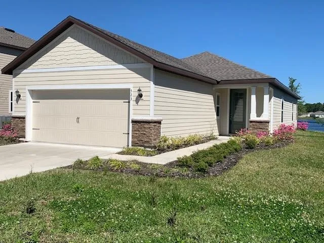 a front view of a house with garden