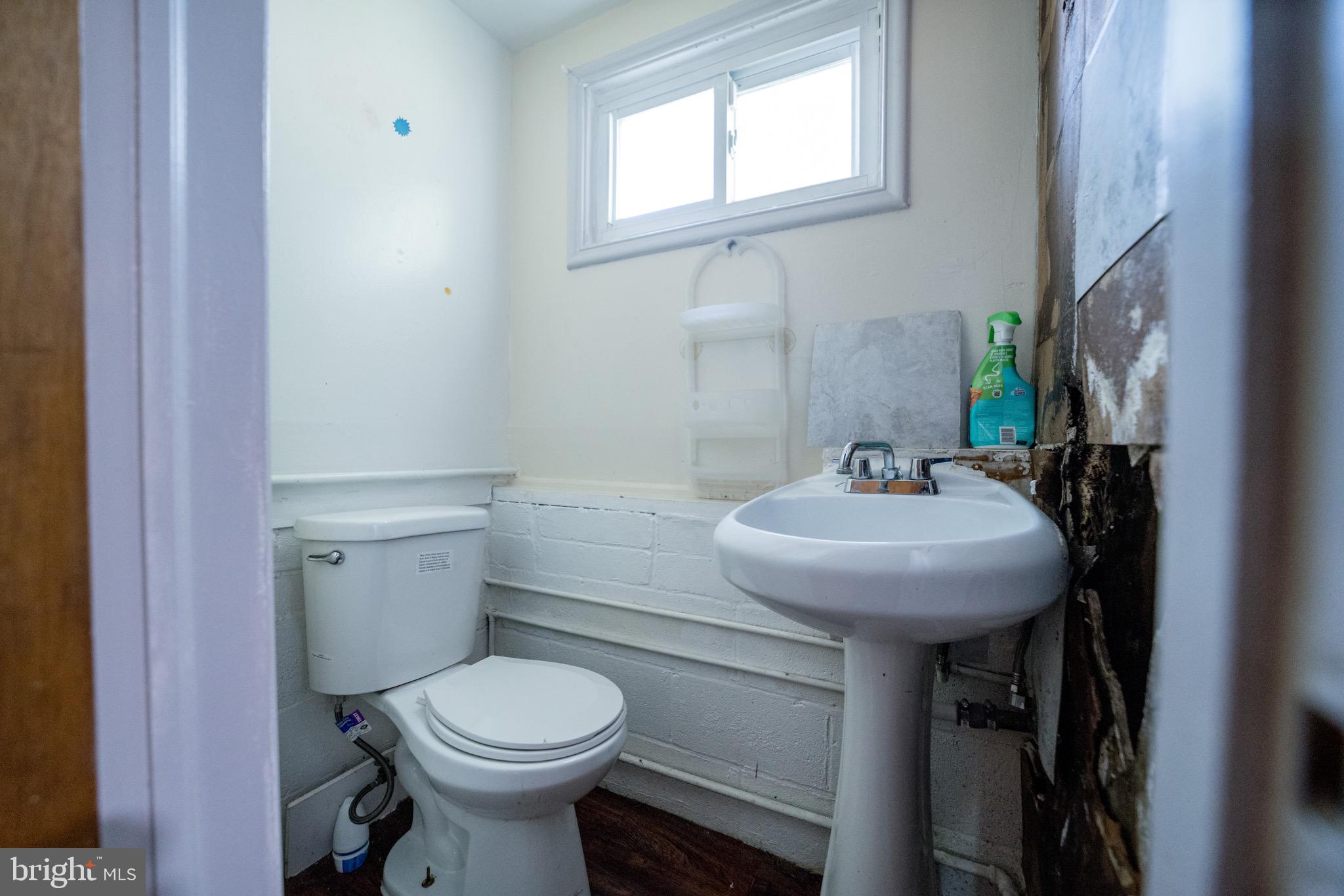 4125 Ronis Road Pikesville, MD 21208 - Photo 31 of 40 a bathroom with a sink toilet and a mirror