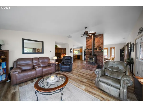 a living room with furniture a fireplace and wooden floor