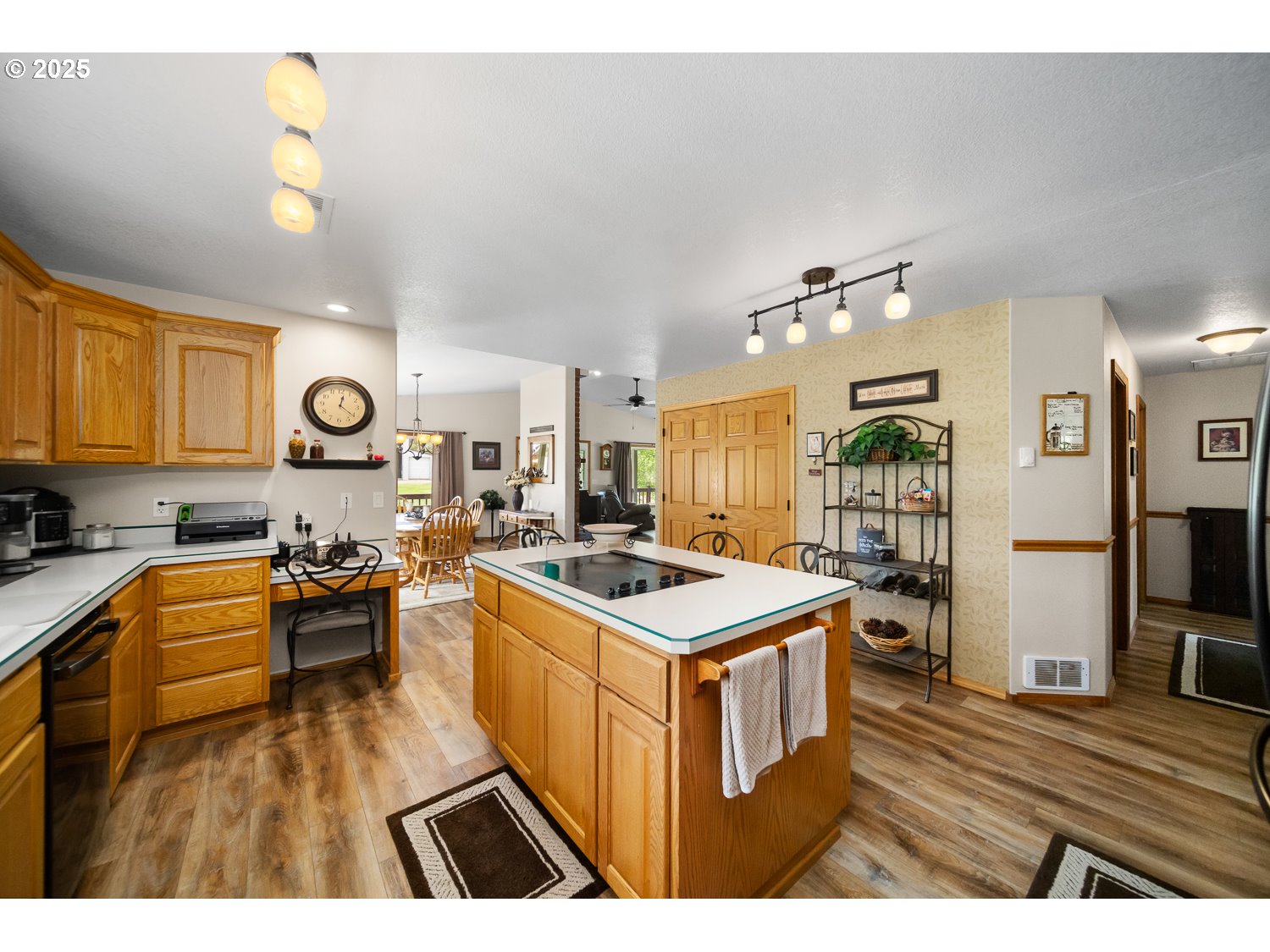 33817 Gage Road Mitchell, OR 97750 - Photo 15 of 48 a open kitchen with kitchen island a stove a sink dishwasher and a dining table with wooden floor