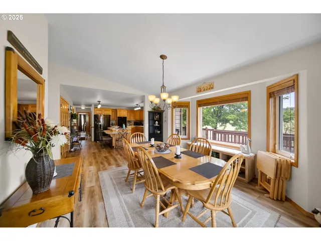 a dining room with furniture wooden floor a chandelier