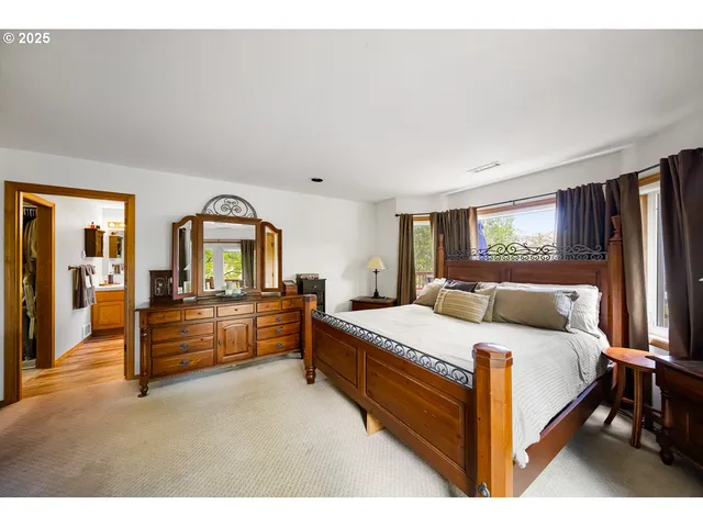 a bedroom with a bed and a large window