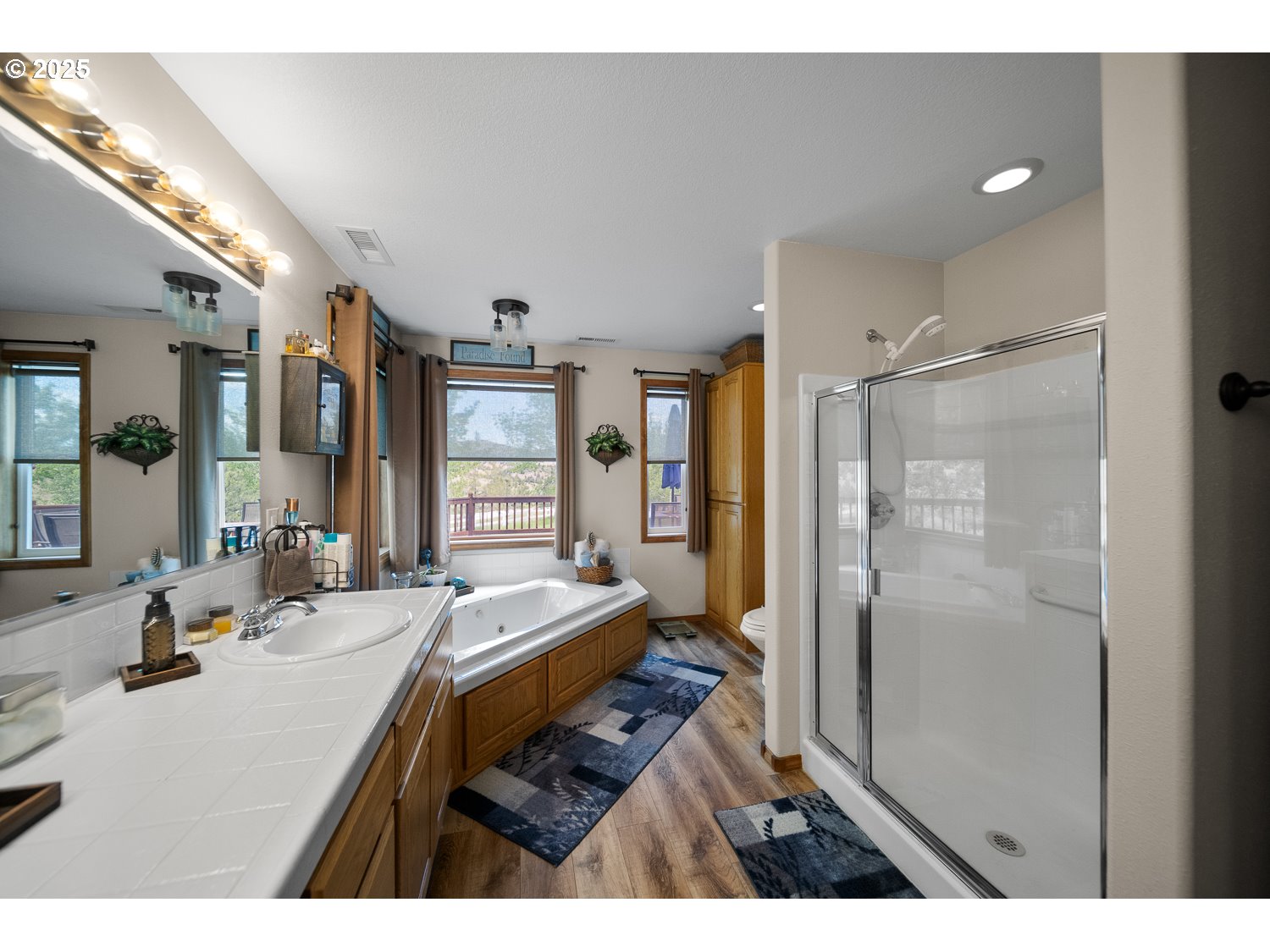 33817 Gage Road Mitchell, OR 97750 - Photo 22 of 48 a bathroom with a double vanity sink a mirror and a shower