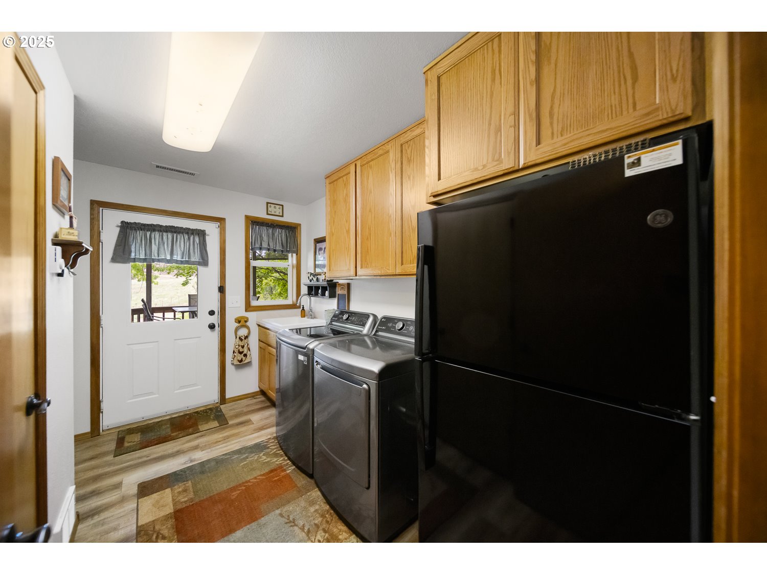 33817 Gage Road Mitchell, OR 97750 - Photo 26 of 48 a kitchen with stainless steel appliances granite countertop a refrigerator a stove and a sink with wooden floor