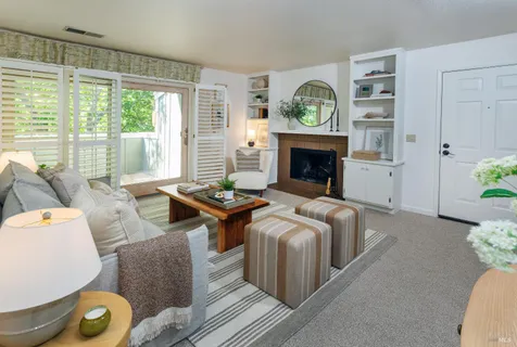 a living room with furniture and a fireplace