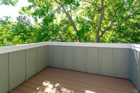 a patio with glass top table and chairs