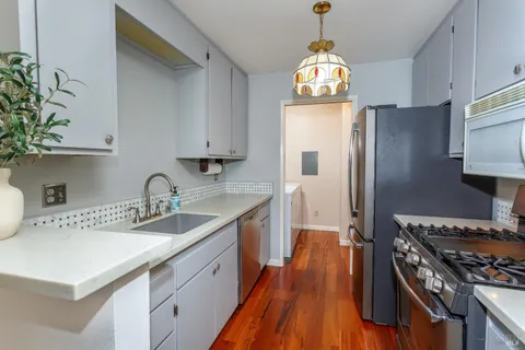 a kitchen with stainless steel appliances granite countertop a sink stove and refrigerator