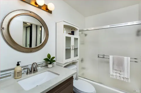 a bathroom with a toilet a sink and a mirror