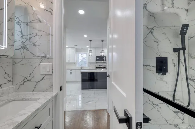 a view of a kitchen with a sink and refrigerator