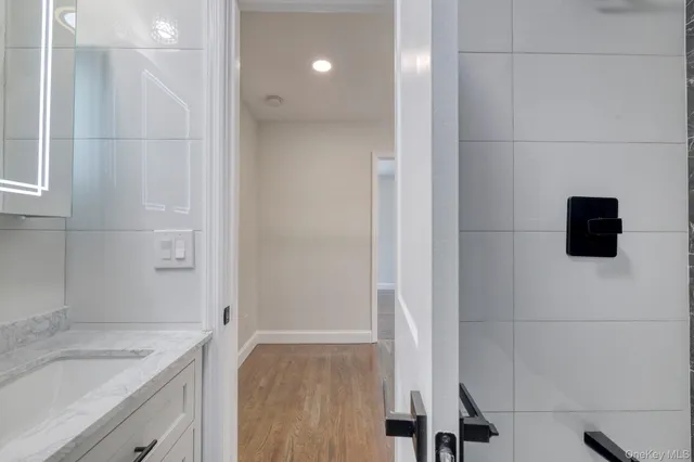a view of a room with wooden floor and window