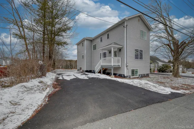 a view of a house with a snow in the yard