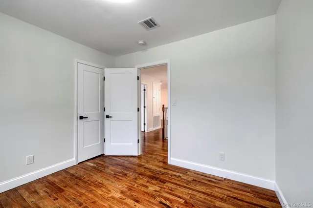 a view of a room with wooden floor and windows