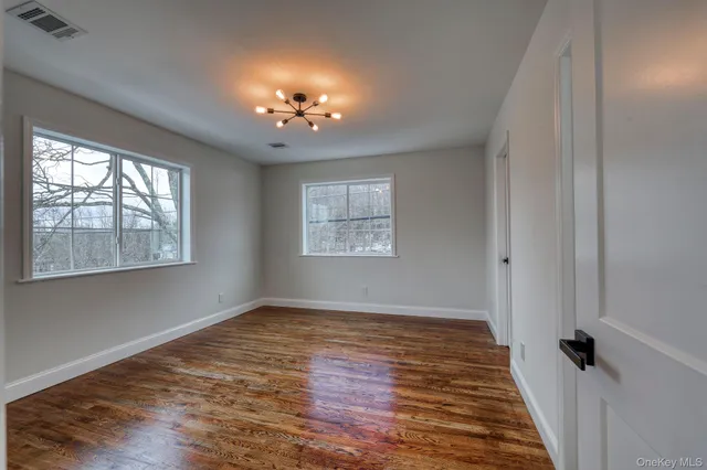 a bathroom with a granite countertop toilet a sink a mirror and shower