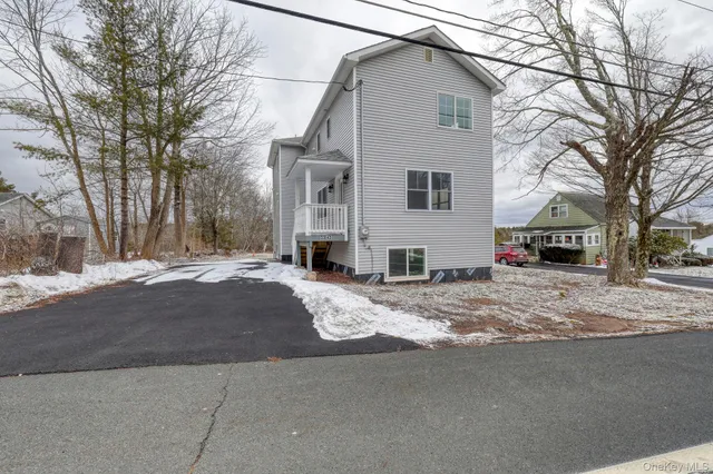 a view of a house with a yard and garage