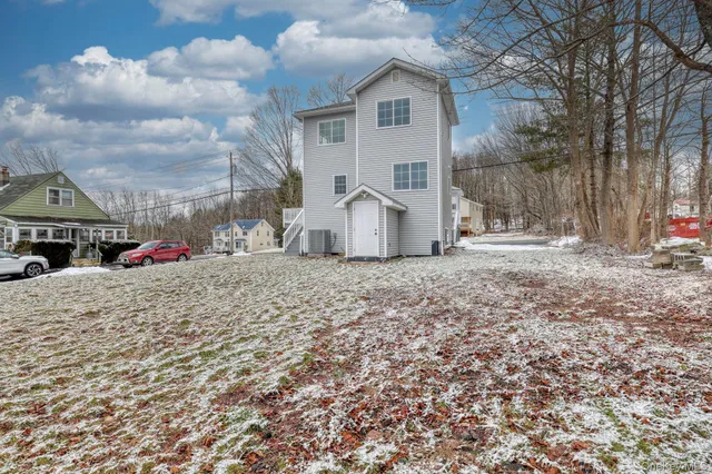 a view of a dry yard with wooden fence