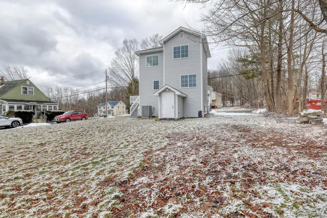 a view of a dry yard covered with snow in the backyard