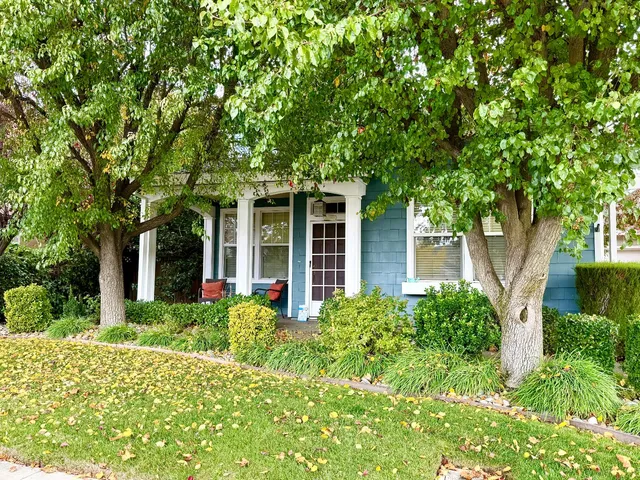 front view of a house with a tree