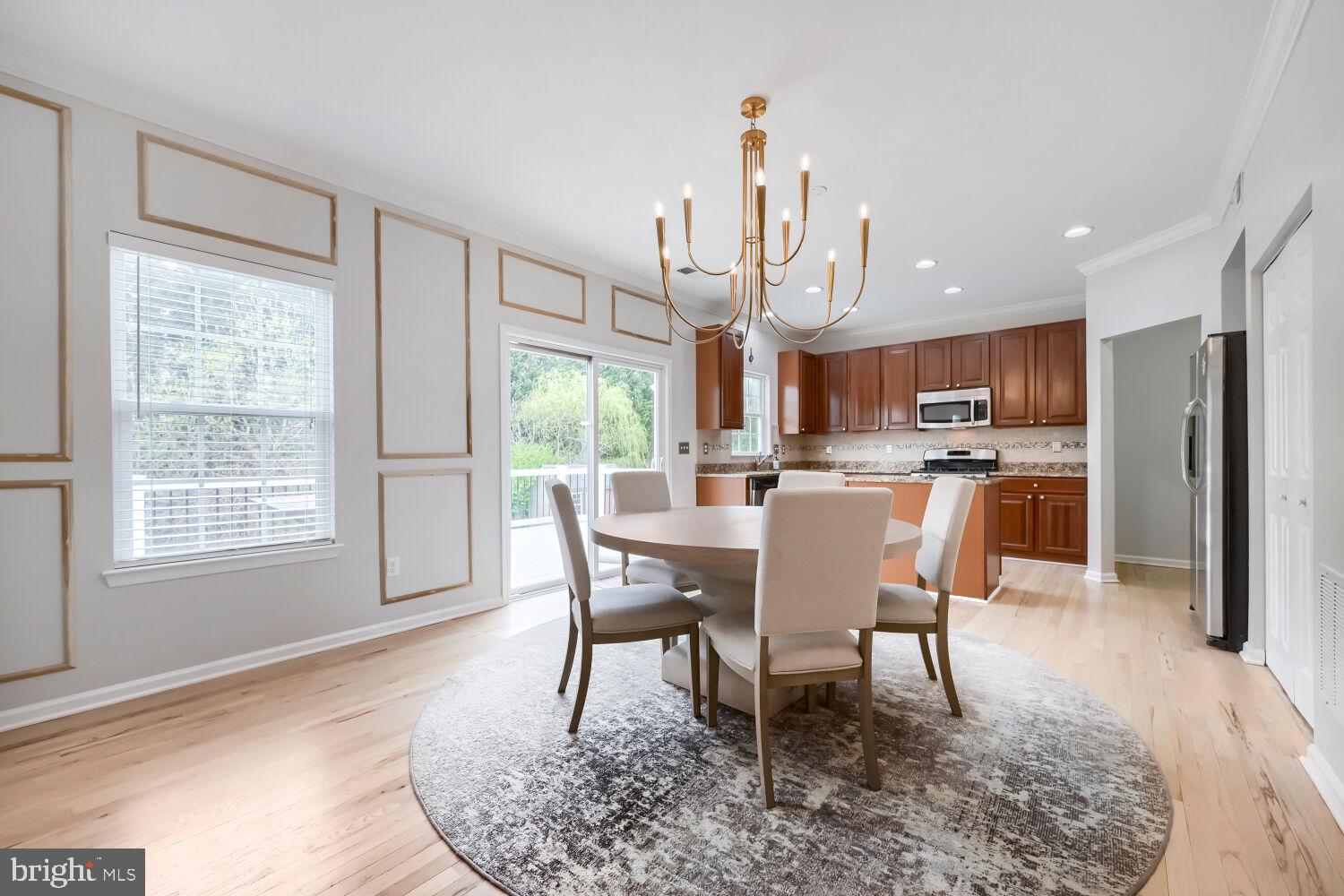 4216 Cross Spring Drive Nottingham, MD 21236 - Photo 12 of 47 a view of a dining room with furniture a rug and wooden floor