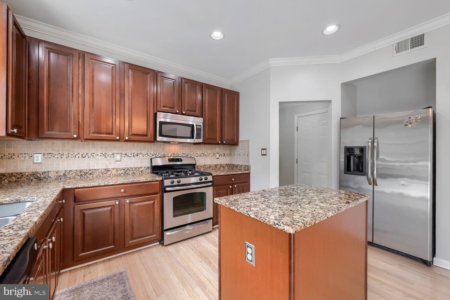4216 Cross Spring Drive Nottingham, MD 21236 - Photo 16 of 47 a kitchen with a stove sink and refrigerator