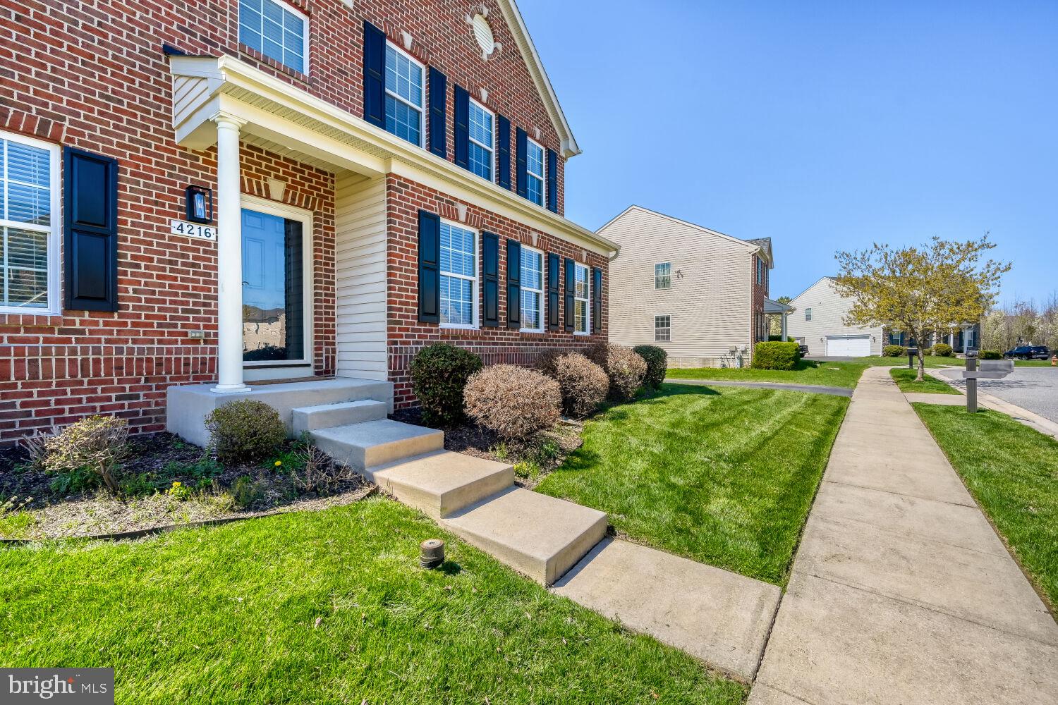 4216 Cross Spring Drive Nottingham, MD 21236 - Photo 3 of 21 Charming brick facade with lush greenery.