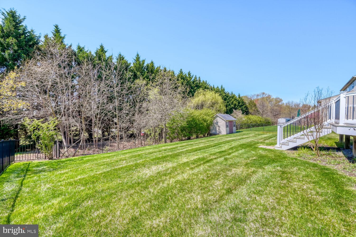 4216 Cross Spring Drive Nottingham, MD 21236 - Photo 10 of 21 Lush green lawn with serene backdrop.