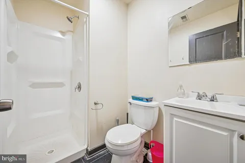 a kitchen with wooden floors stainless steel appliances a refrigerator and a island