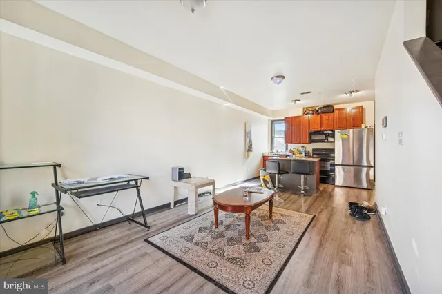 a view of a room with bed and wooden floor