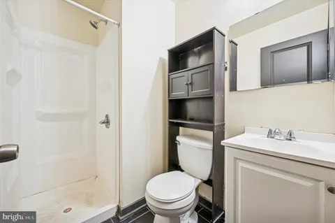 a bathroom with a toilet sink and shower
