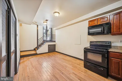 a kitchen with stainless steel appliances granite countertop a stove microwave and refrigerator