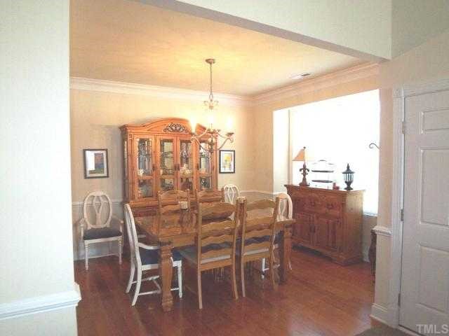 9504 Dellbrook Court Raleigh, NC 27617 - Photo 2 of 12 Open and spacious the dining room still gives you a warm and cozy feeing.