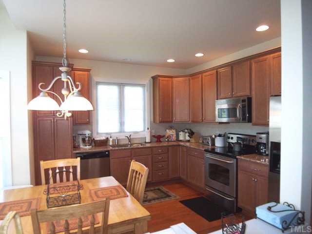 9504 Dellbrook Court Raleigh, NC 27617 - Photo 4 of 12 Large Kitchen with plenty of cabinets, granite countertops and stainless steel appliances will delight cooks of all levels.