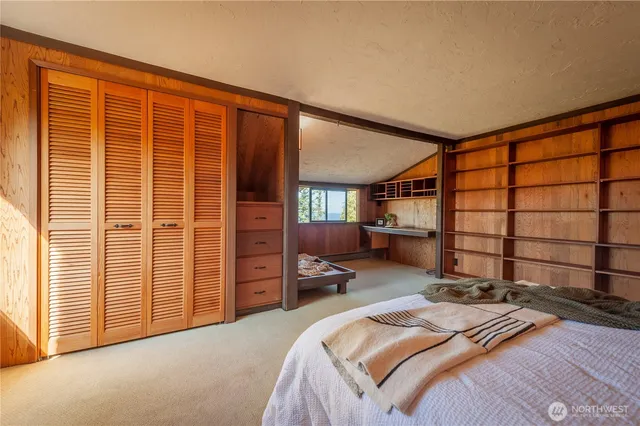 a room with a large window and potted plant on the wall