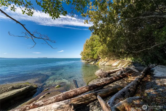 a view of a fountain in front of a house with a yard