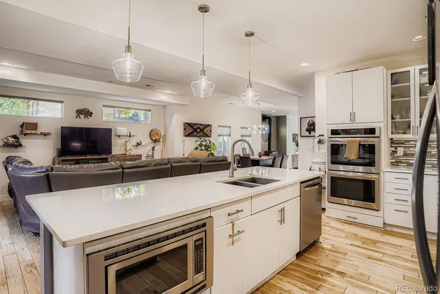 a kitchen with a sink a stove and a refrigerator