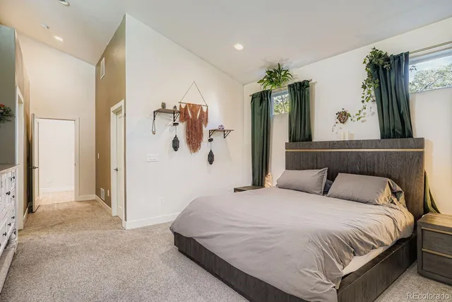 a bedroom with a large bed mirror and window