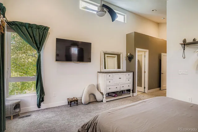 a bedroom with furniture and a flat tv screen
