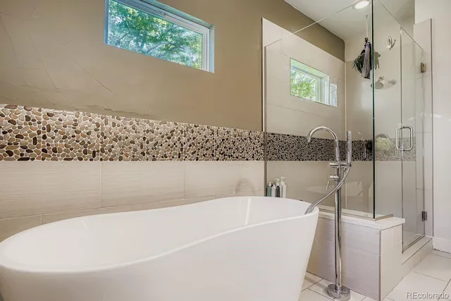 a bathroom with a bathtub and a shower