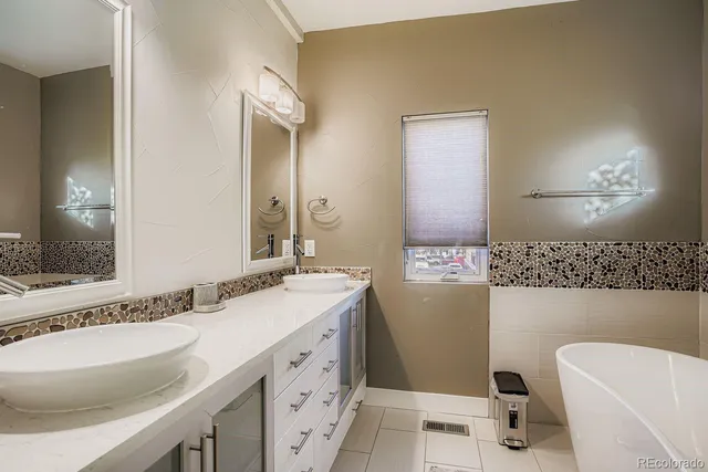 a bathroom with a granite countertop sink mirror vanity and a toilet