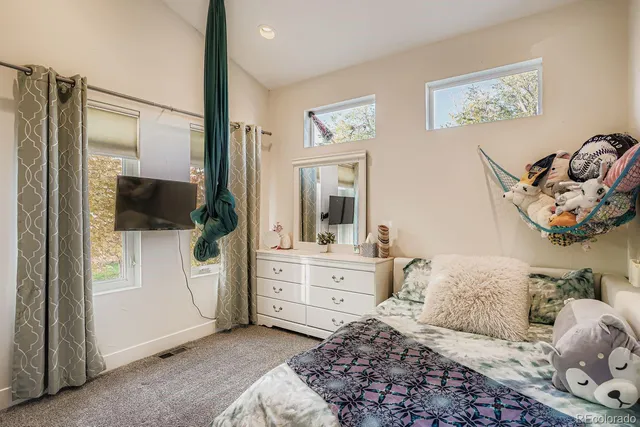 a bedroom with a large bed and a window