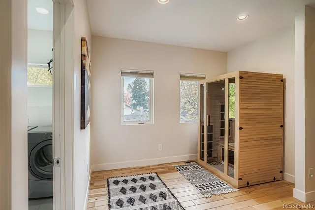 a view of hallway with walk in closet and a window